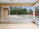Enclosed lanai with tile flooring offering backyard views with access to the outdoors at 2741 Beaver Dr, Deltona, FL 32725
