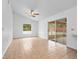 Inviting living room featuring a ceiling fan, tile flooring, and sliding glass door access to a screened porch at 2741 Beaver Dr, Deltona, FL 32725