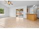 Open-concept living room with tile floors, a ceiling fan, and sliding door access to a screened porch at 2741 Beaver Dr, Deltona, FL 32725