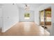 Bright living room featuring a ceiling fan, tile floors, and sliding door access at 2741 Beaver Dr, Deltona, FL 32725