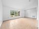 Bright, spacious living room with tile flooring and a large window with view to the front yard at 2741 Beaver Dr, Deltona, FL 32725