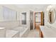 Bright bathroom with a soaking tub, separate shower, and a large window for natural light at 2809 Gulf Winds Ct, Oviedo, FL 32765