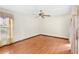This room features a ceiling fan, hardwood floors, and a large window, creating a cozy space at 2809 Gulf Winds Ct, Oviedo, FL 32765