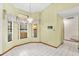 The dining area with tile floors features multiple windows with curtains and a chandelier at 2809 Gulf Winds Ct, Oviedo, FL 32765
