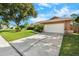 View of the home's driveway leading to the two car garage door on a sunny day at 2809 Gulf Winds Ct, Oviedo, FL 32765