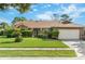 Charming single-story home with well-maintained landscaping, lush lawn and a two car garage at 2809 Gulf Winds Ct, Oviedo, FL 32765