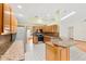 Spacious kitchen area with wooden cabinets, granite countertops, tile floors, and modern stainless steel appliances at 2809 Gulf Winds Ct, Oviedo, FL 32765