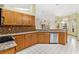 Well-lit kitchen showcases wood cabinets, granite countertops, tile backsplash, and stainless steel appliances at 2809 Gulf Winds Ct, Oviedo, FL 32765