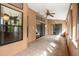 Enclosed lanai showcasing tile floors, textured walls, ceiling fan, and access to the interior of the home at 2809 Gulf Winds Ct, Oviedo, FL 32765