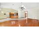 Open-concept living room with hardwood and tile flooring, natural lighting, and a view of the kitchen area at 2809 Gulf Winds Ct, Oviedo, FL 32765