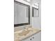Close-up of a bathroom vanity with a marble countertop and decorative mirror at 2930 Candela Ct, Apopka, FL 32703