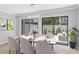 Dining room with modern light fixture and sliders to patio with outdoor seating at 2930 Candela Ct, Apopka, FL 32703