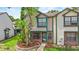Inviting two-story townhouse with manicured landscaping and a brick facade at 2930 Candela Ct, Apopka, FL 32703