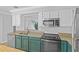 Updated kitchen with granite counters, stainless steel appliances, and staircase view at 2930 Candela Ct, Apopka, FL 32703