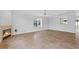 Well-lit living area with tile flooring, fireplace, and a passthrough to the kitchen at 2930 Candela Ct, Apopka, FL 32703
