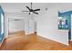 Spacious bedroom with hardwood floors, fan, and closet with mirror doors at 2930 Candela Ct, Apopka, FL 32703