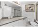 Bright bathroom featuring a granite vanity, white cabinets, and a shower with glass doors at 3023 S Atlantic Ave # 2050, Daytona Beach, FL 32118