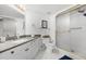 Bathroom with granite countertop vanity, white cabinets, and a glass-enclosed shower with gold trim at 3023 S Atlantic Ave # 2050, Daytona Beach, FL 32118