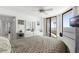 Inviting bedroom with tile floors, balcony access, and ample storage with a large dresser and vanity at 3023 S Atlantic Ave # 2050, Daytona Beach, FL 32118