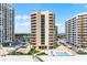 High-rise exterior view offering a glimpse of the luxurious balconies, community pool, and vibrant city life at 3023 S Atlantic Ave # 2050, Daytona Beach, FL 32118