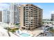 Multi-story building showcasing a community pool, landscaping, and parking, blending comfort and convenience at 3023 S Atlantic Ave # 2050, Daytona Beach, FL 32118