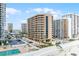 Elevated exterior showcasing balconies, parking, community pool and nearby buildings enhancing urban living at 3023 S Atlantic Ave # 2050, Daytona Beach, FL 32118