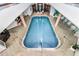 Indoor pool surrounded by white tile and architectural columns at 3023 S Atlantic Ave # 2050, Daytona Beach, FL 32118