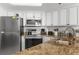 A kitchen with white cabinets, stainless steel appliances and granite countertops at 3023 S Atlantic Ave # 2050, Daytona Beach, FL 32118
