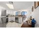 Bright kitchen with white cabinets, stainless appliances, granite counters and dining area at 3023 S Atlantic Ave # 2050, Daytona Beach, FL 32118