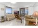Cozy living room with tile flooring, comfortable seating, and a view of the ocean and balcony at 3023 S Atlantic Ave # 2050, Daytona Beach, FL 32118
