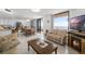 Open-concept living and dining area with tile flooring, balcony access, and cozy seating arrangement at 3023 S Atlantic Ave # 2050, Daytona Beach, FL 32118