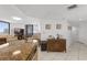 A well-lit living room with tile floors, furniture, and a view of the balcony and ocean at 3023 S Atlantic Ave # 2050, Daytona Beach, FL 32118