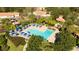 Aerial view of community pool, playground, and lush landscaping at 3065 Yellow Lantana Ln, Kissimmee, FL 34747