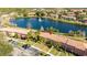 Aerial view of the property showing its location near a scenic lake and community pool at 3065 Yellow Lantana Ln, Kissimmee, FL 34747