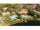Aerial view of community amenities with pools, lounging areas, and lush landscaping at 3065 Yellow Lantana Ln, Kissimmee, FL 34747