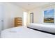 Comfortable bedroom with twin beds, dresser, and view of the landscape at 3065 Yellow Lantana Ln, Kissimmee, FL 34747