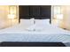Bedroom featuring a comfortable king-size bed with a padded headboard and soft lighting at 3065 Yellow Lantana Ln, Kissimmee, FL 34747