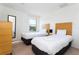 Bright bedroom featuring two beds, large window with view, and modern decor at 3065 Yellow Lantana Ln, Kissimmee, FL 34747
