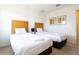 Cozy bedroom with two twin beds, a small table lamp and a picture frame at 3065 Yellow Lantana Ln, Kissimmee, FL 34747