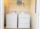 Laundry room featuring a washer, dryer, and storage shelf at 3065 Yellow Lantana Ln, Kissimmee, FL 34747