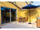 Cozy patio with outdoor seating, a blue umbrella, and a hot tub at 3065 Yellow Lantana Ln, Kissimmee, FL 34747