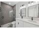 Modern bathroom featuring a double vanity with quartz countertops and a sleek glass-enclosed shower with gray tiling at 3159 Sw 127Th Lane Rd, Ocala, FL 34473