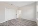 Bedroom with wood-look flooring, a closet, and a doorway leading to another room at 3159 Sw 127Th Lane Rd, Ocala, FL 34473