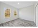 A bedroom features neutral-toned walls and flooring, complemented by natural light from the window at 3159 Sw 127Th Lane Rd, Ocala, FL 34473