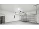 Spacious garage with a garage door, water heater, and painted walls at 3159 Sw 127Th Lane Rd, Ocala, FL 34473