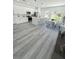 Modern kitchen with white cabinets, stainless steel appliances, an island, and an adjacent dining area at 3159 Sw 127Th Lane Rd, Ocala, FL 34473
