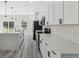 A kitchen featuring white cabinets, stainless steel appliances, a large island, and stylish pendant lighting at 3159 Sw 127Th Lane Rd, Ocala, FL 34473