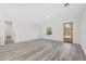 Open living area featuring wood-look flooring, a modern front door, and bright natural light at 3159 Sw 127Th Lane Rd, Ocala, FL 34473
