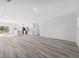Open living space with wood-look floors, white walls, and a bright kitchen area at 3159 Sw 127Th Lane Rd, Ocala, FL 34473