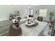 Bright living room with white sofa, modern furniture, and wood-look flooring at 3159 Sw 127Th Lane Rd, Ocala, FL 34473